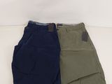 two pairs of men ' s shorts sitting on top of each other