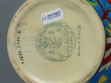 a blue and yellow plate with a picture of a seal on it