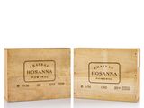 two wooden boxes with labels on them sitting on a white surface