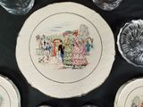 a plate with a picture of people on it on a table