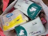 three packages of diapers in a bag on the floor