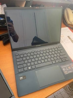a laptop that is sitting on a desk in front of a computer monitor