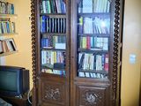 a large book case in the corner of a living room