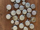 silver plated metal buttons on a wooden surface