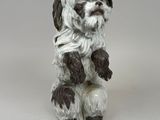 a small figurine of a dog sitting on its hind legs