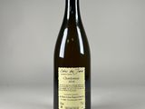 a bottle of wine sitting on top of a white table