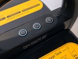 a close up of a black and yellow steam iron