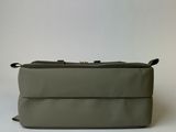 an image of a grey toilet bag sitting on top of a white table