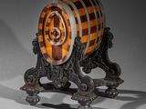 a wooden barrel sitting on top of a metal stand