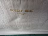 the bag is white and has a gold logo on it