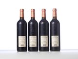 three bottles of wine are lined up on a table