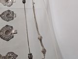 a glass display case with a bunch of silver jewelry on it
