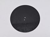 a close up of a black disc on a white surface