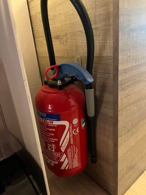 a fire extinguisor attached to a wall in a room