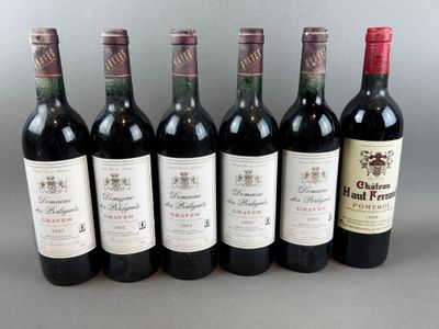 six bottles of wine are lined up in a row on a table
