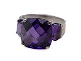 an image of a close up of a ring with a purple stone