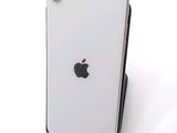 a close up of a white iphone with an apple logo on the back of it