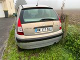 a small car that is parked on the side of the road