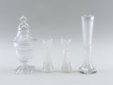 three clear glass vases sitting next to each other on a white surface
