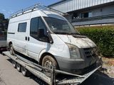a white van that is being towed by a flatbed truck
