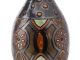 a black vase with a brown and green design on it