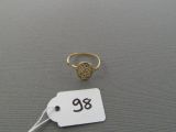 a close up of a gold ring with a tag on it