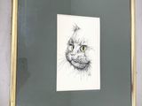 a picture of a drawing of a cat hanging on a wall