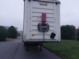 a white truck with a pink bow on the back