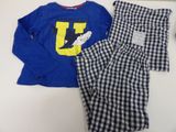 a pair of pajamas are laying on top of a table
