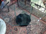 a glass table with a glass top in a room full of chairs