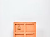 an empty wooden box sitting on top of a white surface