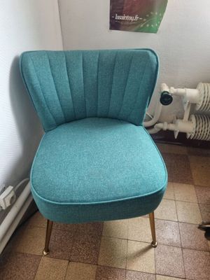 a blue chair that is sitting in the corner of a room
