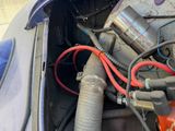 an image of a car engine with the hood open and wires attached to it