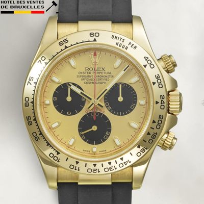 an image of a gold and black watch on a white surface
