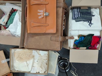 many boxes of clothes and other items that are on the floor