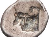 an old coin with a bow on the side of it