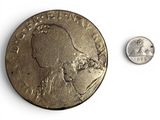a coin and a dime on a white surface