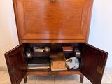 a wooden cabinet with a door open on the floor