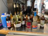 many bottles of alcohol sitting on a counter in a restaurant