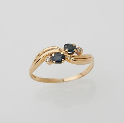a close up of a gold ring with black and white diamonds
