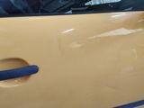a yellow car door with a blue handle on it
