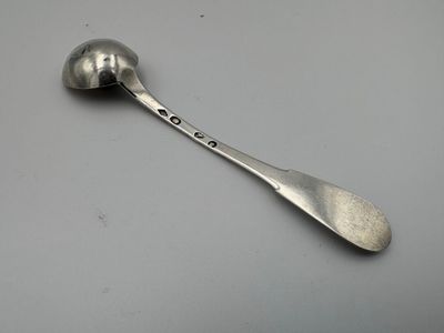 silver spoon with the word love on it sitting on top of a table