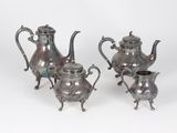 two silver teapots and a coffee pot on a stand
