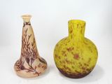 two vases sitting next to each other on a white surface