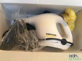 a white hand held vacuum in a box with a yellow sponge