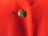a close up of a red coat with a gold button