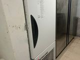 an image of a kitchen with a refrigerator and a washing machine