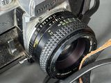 a camera with a strap around it sitting on a table