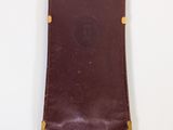 leather case for a cell phone on a white surface
