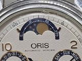 a close up of a wrist watch with a sun and moon on it